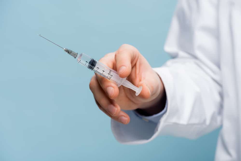 Close-up of medical professional holding syringe vaccine